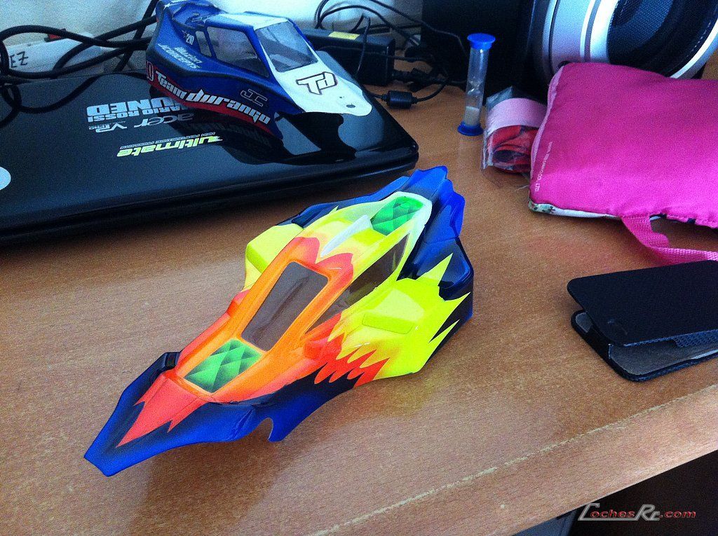 Varias carrocerias de lexan pintadas de colores sobre la mesa de trabajo