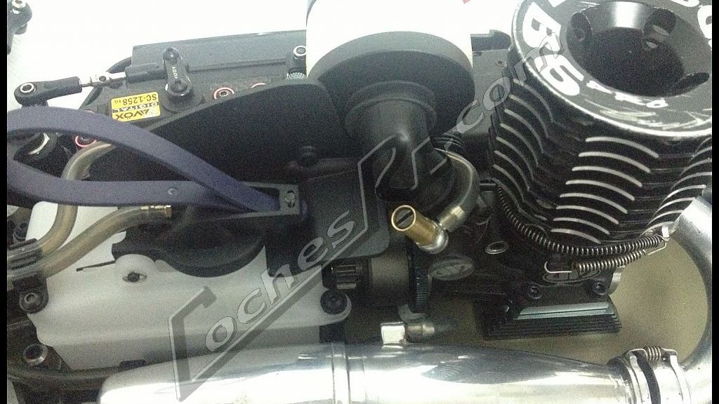 Motor nitro de coche RC con su escape montado en el chasis
