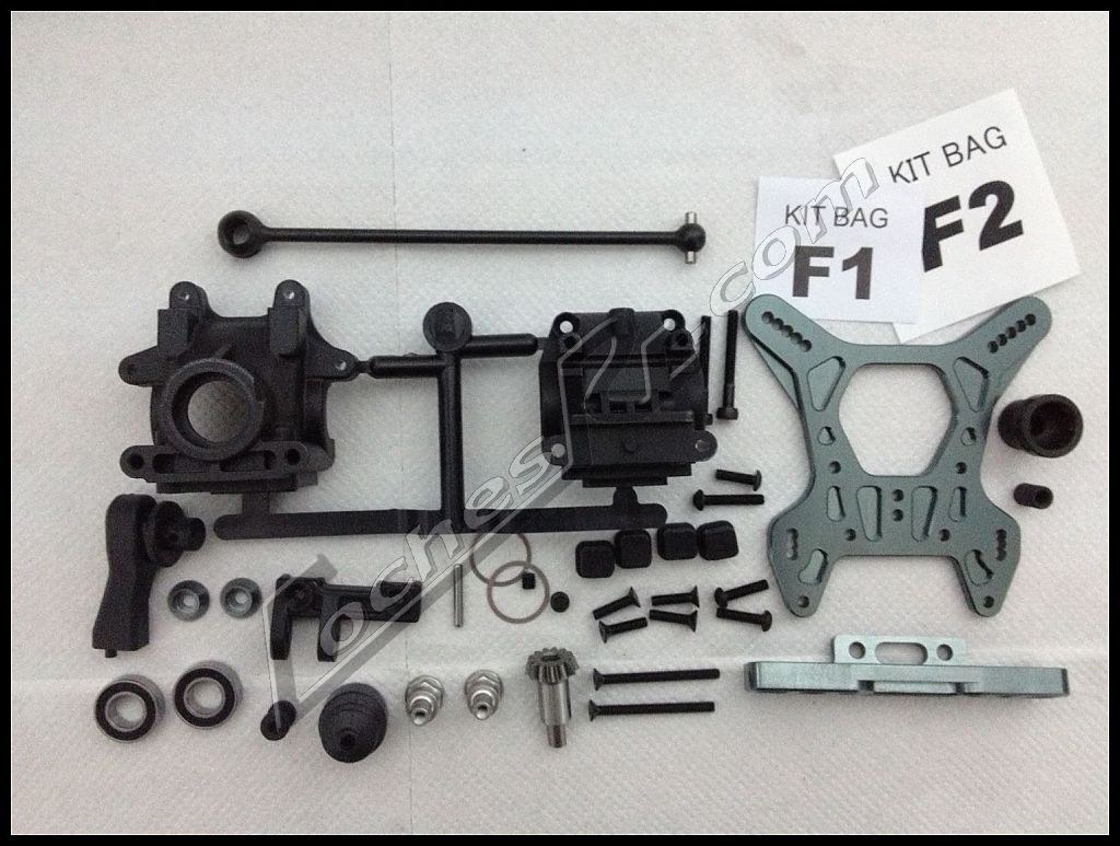 Piezas sueltas de un kit de coche RC ordenadas sobre una toalla en la mesa de trabajo